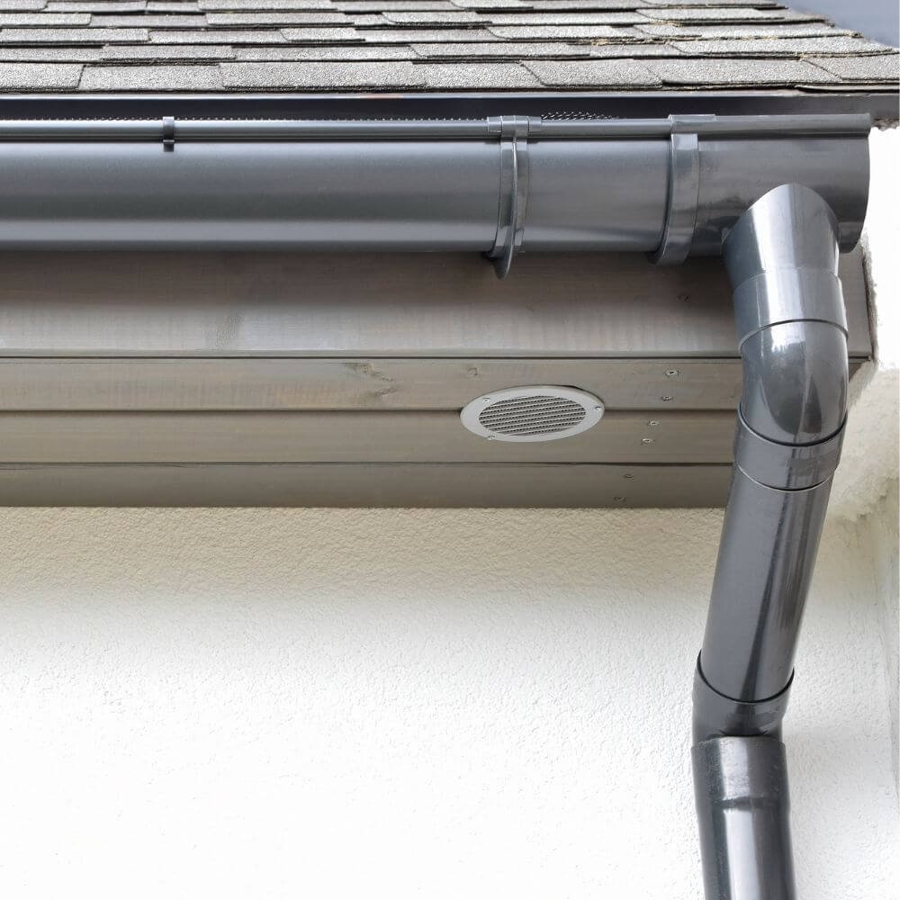 Professional gutter cleaning service on a home in Port Talbot using safe ground-based equipment.